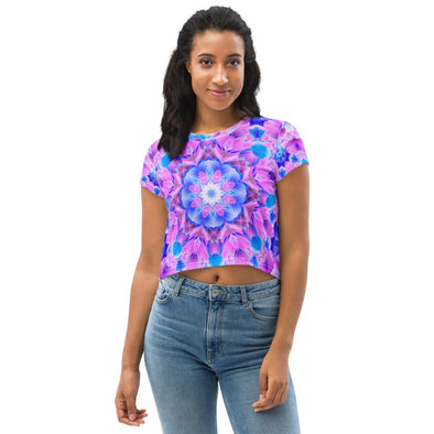 Photograph of a model wearing a unisex Bleace MetaParty Vibes Kaleidoscopic pink, light blue, Trippy Visual crop top shirt.  