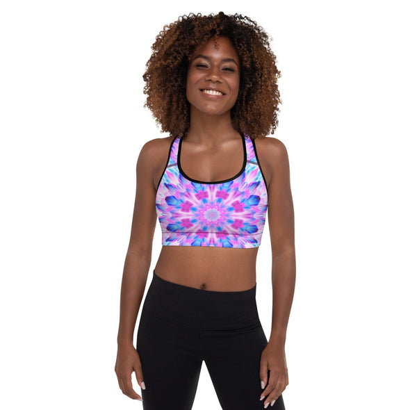 Photograph of a model wearing a Bleace MetaParty Vibes Kaleidoscopic pink, light blue, Trippy Visual sports bra.  