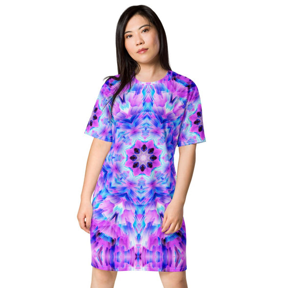 Photograph of a model wearing a Bleace unisex MetaParty Vibes Kaleidoscopic pink, light blue, Trippy Visual tee shirt dress.  