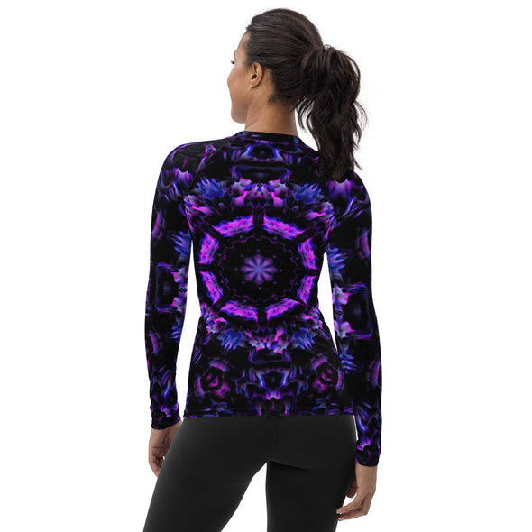 Photograph of a model wearing Bleace unisex MetaParty Vibes Kaleidoscopic purple, blue, and pink, Trippy Visual rash guard.  