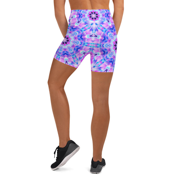 Photograph of a model wearing Bleace unisex MetaParty Vibes Kaleidoscopic pink, light blue, Trippy Visual yoga shorts.  