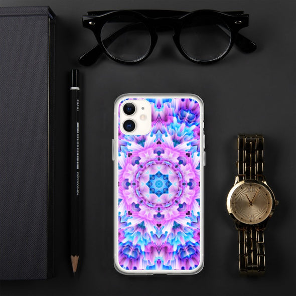 Product photograph of a Bleace Iphone case that has a kaleidoscope image made of pink, blue and purple colors in the foreground against a table backdrop next to a watch and eyeglasses.